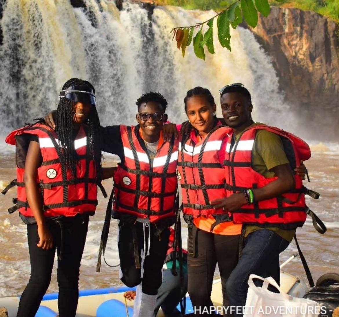 HappyFeet guests in life jackets at a waterfall